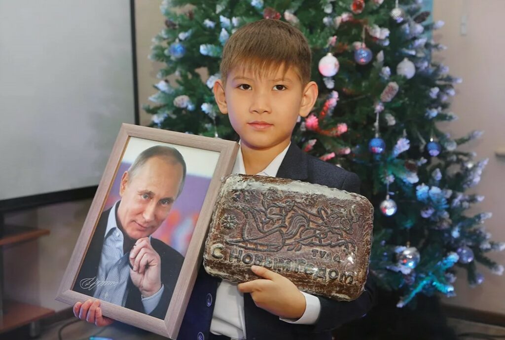На фото мальчик получивший подарок на новый Год от Путина в 2022 году.